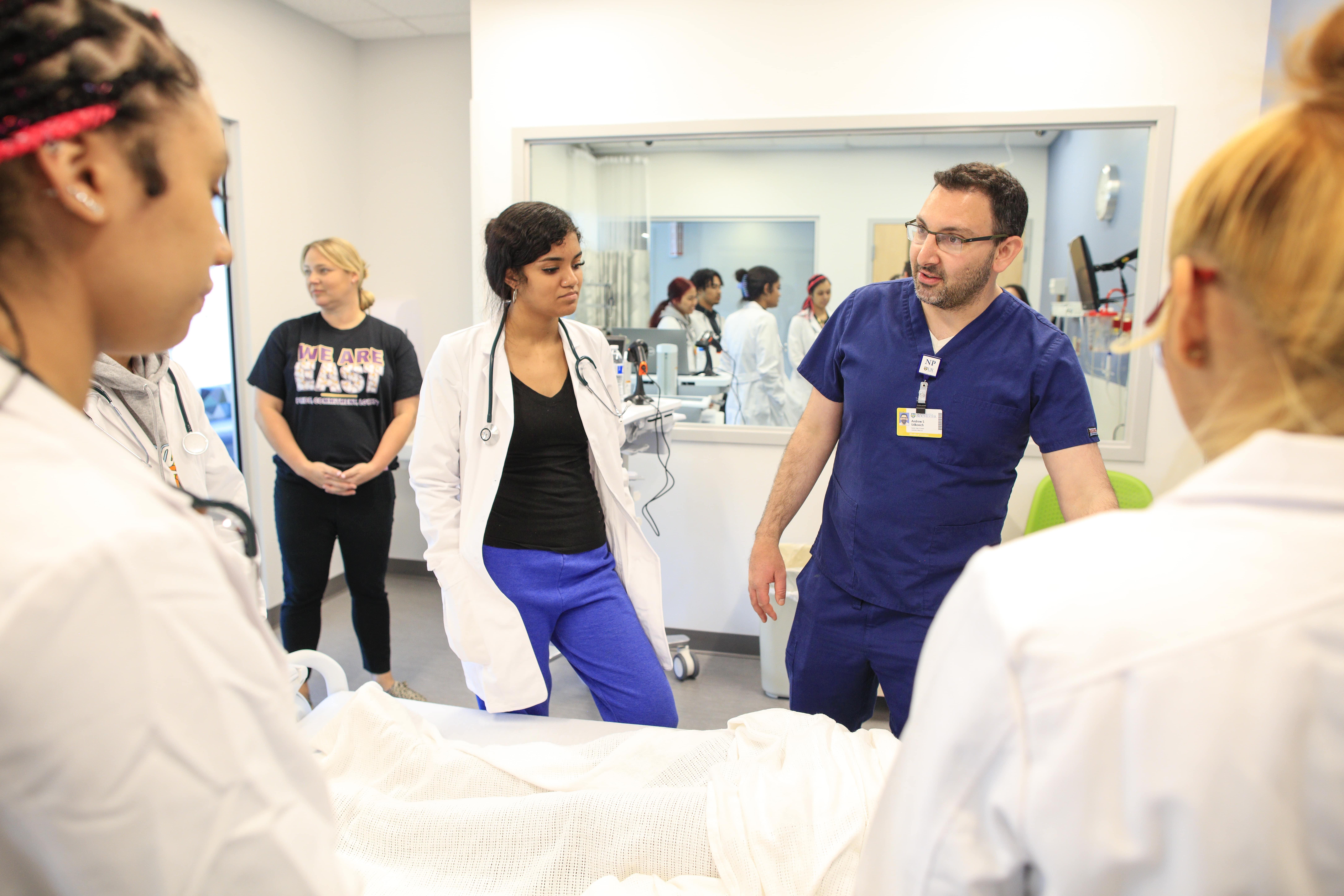 East High student Martha Beltran listens to pediatric nurse practitioner Andrew Udkovich during a lesson in the School of Nursing skills lab.